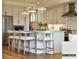 A kitchen island with bar stool seating sits below pendant lights, with stainless appliances at 1001 Kingbird Ln # 15, Clover, SC 29710