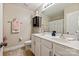 Bathroom with dual sinks, white cabinetry, and a decorative mirror offers functionality and style at 10044 Markus Dr, Mint Hill, NC 28227