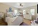 Bright bedroom is adorned with white furniture, multiple windows, and whimsical decor at 10044 Markus Dr, Mint Hill, NC 28227