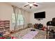 Bedroom with a ceiling fan, large window, and a comfortable rug, creating a relaxing ambiance at 10044 Markus Dr, Mint Hill, NC 28227