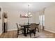 An elegant dining room with a stylish chandelier and wood flooring creates an inviting space at 10044 Markus Dr, Mint Hill, NC 28227