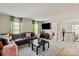 Second-story living area with large TV, dark leather couches and access to other rooms at 10044 Markus Dr, Mint Hill, NC 28227