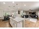 Bright, open-concept kitchen and living room area; the kitchen has a spacious island with bar stool seating at 10044 Markus Dr, Mint Hill, NC 28227
