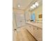 Bathroom with double closets, a light colored vanity, a large mirror, and tile floors at 1025 N Sharon Amity Rd, Charlotte, NC 28211