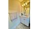 Bathroom featuring a single vanity, light fixtures, and a tile floor at 1025 N Sharon Amity Rd, Charlotte, NC 28211