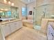 Elegant bathroom with granite countertops, tile flooring, and a luxurious tub, creating a serene and relaxing space at 1025 N Sharon Amity Rd, Charlotte, NC 28211