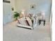 Spacious carpeted bedroom featuring a bed, lamps, and side tables at 1025 N Sharon Amity Rd, Charlotte, NC 28211