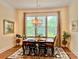 Bright dining room with chandelier, large window, and hardwood floors, perfect for entertaining guests or Gathering meals at 1025 N Sharon Amity Rd, Charlotte, NC 28211