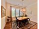 Cozy dining room featuring a chandelier, natural light, and a decorative rug, creating a warm and inviting atmosphere at 1025 N Sharon Amity Rd, Charlotte, NC 28211