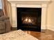 Cozy fireplace with a black marble surround and white mantel, set on hardwood flooring with an accent rug at 1025 N Sharon Amity Rd, Charlotte, NC 28211