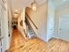 Inviting foyer with hardwood floors, elegant staircase, and traditional lighting at 1025 N Sharon Amity Rd, Charlotte, NC 28211