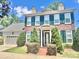 Two-story brick home with green shutters, manicured front yard, and attached garage at 1025 N Sharon Amity Rd, Charlotte, NC 28211