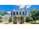 Charming two-story brick home boasts lush landscaping and dark green shutters at 1025 N Sharon Amity Rd, Charlotte, NC 28211