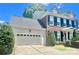 Side view of the house showing the garage and partial front elevation at 1025 N Sharon Amity Rd, Charlotte, NC 28211