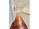 Hallway featuring hardwood floors, white walls, and a wood railing at 1025 N Sharon Amity Rd, Charlotte, NC 28211