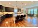 Modern kitchen with a center island, stylish lighting, and open to the dining area at 1025 N Sharon Amity Rd, Charlotte, NC 28211