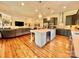 Open kitchen with a large island featuring a wine cooler and an open layout to the living room at 1025 N Sharon Amity Rd, Charlotte, NC 28211