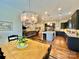 Open-concept kitchen and dining area with hardwood floors and modern chandelier at 1025 N Sharon Amity Rd, Charlotte, NC 28211