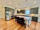 Spacious kitchen with stainless steel appliances, large island, and hardwood floors at 1025 N Sharon Amity Rd, Charlotte, NC 28211