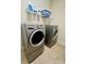 This laundry room features modern front loading washer and dryer units and storage shelves at 1025 N Sharon Amity Rd, Charlotte, NC 28211