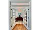 Home office featuring French doors, neutral walls, and a large desk at 1025 N Sharon Amity Rd, Charlotte, NC 28211