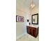 Elegant powder room featuring a dark wood vanity with a marble countertop and unique light fixture at 1025 N Sharon Amity Rd, Charlotte, NC 28211