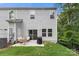 Back of house with outdoor seating area and grill on a small patio at 1028 Maltby St, Charlotte, NC 28217