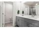 Modern bathroom featuring double vanity, granite counters, and walk-in shower at 1028 Maltby St, Charlotte, NC 28217