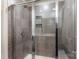 Modern bathroom featuring tiled shower with glass door and built-in shelving at 1028 Maltby St, Charlotte, NC 28217