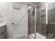 Modern bathroom featuring tiled shower with glass door and built-in shelving at 1028 Maltby St, Charlotte, NC 28217