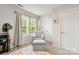 Cozy Bedroom with glider, window, and neutral decor at 1028 Maltby St, Charlotte, NC 28217