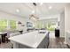 Open kitchen layout with island seating, dining area, and a view into the living room at 1028 Maltby St, Charlotte, NC 28217