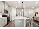 Open kitchen with stainless steel appliances, island seating, and modern lighting fixtures at 1028 Maltby St, Charlotte, NC 28217