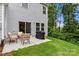 Outdoor patio featuring a dining set, grill, sliding glass door, and a view of the backyard and trees at 1028 Maltby St, Charlotte, NC 28217