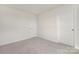 Bedroom with neutral carpet and walls, with two white doors and trim, ready for personalization to create a cozy retreat at 1039 20Th Avenue Se Loop, Hickory, NC 28602