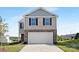 Two-story home featuring stone accents, a two-car garage, neutral siding, and a well manicured lawn at 1039 20Th Avenue Se Loop, Hickory, NC 28602