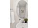 Cozy powder room showcasing a pedestal sink, round mirror, and decorative accents at 1039 20Th Avenue Se Loop, Hickory, NC 28602