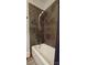 Bathroom features a tub with slate tile surround and a shower with a detachable head at 105 N Central Ave, Belmont, NC 28012