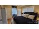 Cozy bedroom with neutral decor and a comfortable black upholstered bed frame at 105 N Central Ave, Belmont, NC 28012