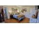 Bedroom with wood flooring, ensuite bathroom, a bed, and natural light at 105 N Central Ave, Belmont, NC 28012