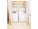 Convenient laundry area with washer, dryer, shelving, and bi-fold doors for easy access and space-saving design at 110 Book Ct, Statesville, NC 28677