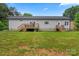Spacious backyard with lush greenery and an exterior view of the home, offering privacy and tranquility at 113 Robinette Ln, Statesville, NC 28625