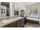 Bathroom features double sinks, vanity, soaking tub, and shower for a luxurious, spa-like experience at 113 Robinette Ln, Statesville, NC 28625