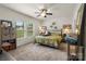 Bright bedroom boasts a ceiling fan, two large windows, and neutral decor for a relaxing space at 113 Robinette Ln, Statesville, NC 28625