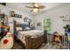 Fun, kid-friendly bedroom with decorative shelves, ceiling fan, and a large window for natural light at 113 Robinette Ln, Statesville, NC 28625