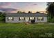 Charming single-story home with a well-manicured lawn and inviting front porch, perfect for relaxing evenings at 113 Robinette Ln, Statesville, NC 28625