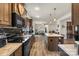 Modern kitchen with a large island, stainless steel appliances, wood floors, and an open floor plan at 113 Robinette Ln, Statesville, NC 28625