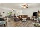 Open-concept living room with a large sectional sofa, dining area, and modern flooring at 113 Robinette Ln, Statesville, NC 28625