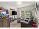 Inviting living room features large windows, neutral walls, and a comfortable gray sofa at 113 Robinette Ln, Statesville, NC 28625