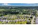An aerial view of a lush green residential community with homes surrounded by trees and landscaping at 116 Maggie Dr, Mount Holly, NC 28120